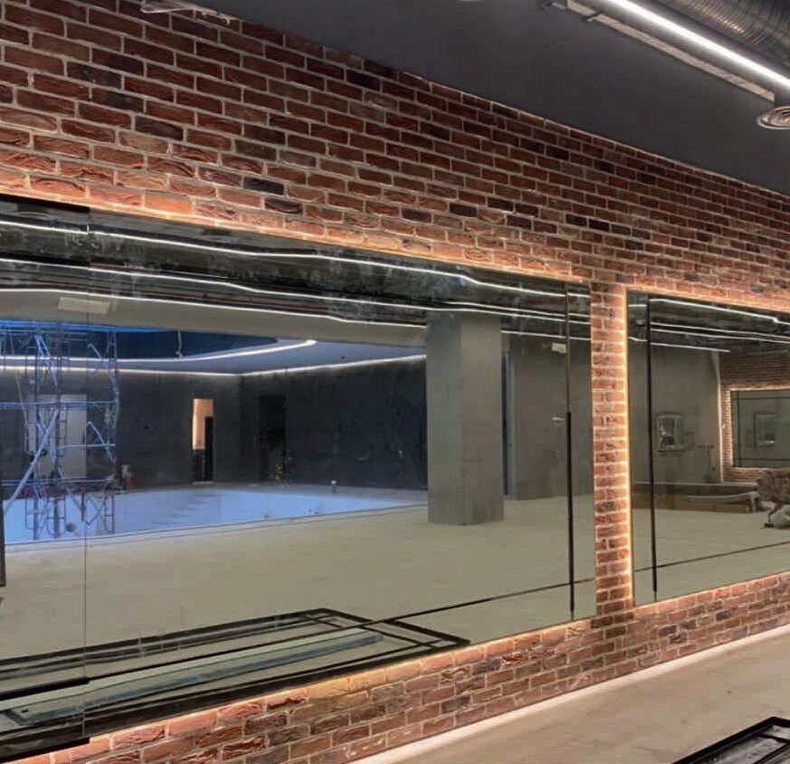 Brick feature wall, glazing and integrated lighting.