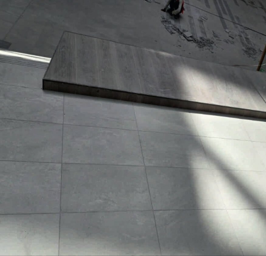 Large-format tiling, laid to a set-out grid.